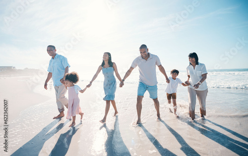 Water, beach and big family together on holiday at the sea or ocean bonding for love, care and happiness. Happy, sun and parents with children or kids and grandparents on a vacation for freedom