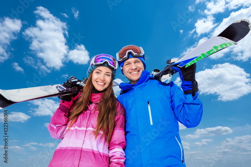 Young couple with skis outdoors