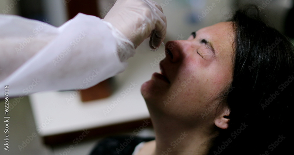 Woman having COVID nose test PCR procedure Woman having COVID nose test PCR procedure