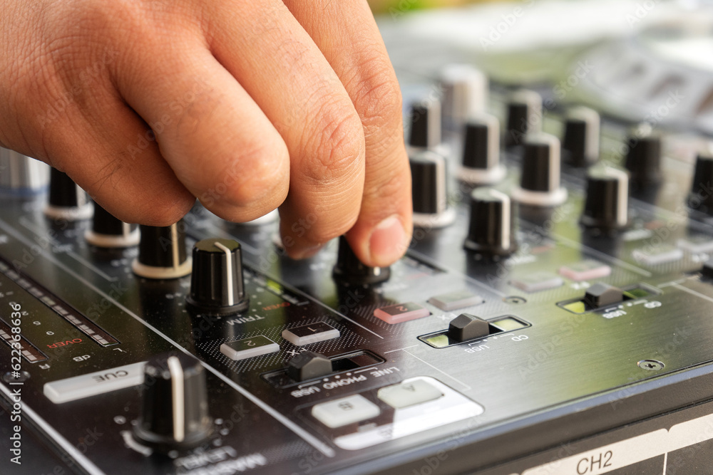 DJ Hands creating and regulating music on dj console mixer in concert party outdoor openair DJ Hands creating and regulating music on dj console mixer in concert party outdoor openair