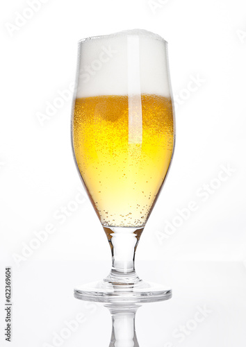 Glass of beer cider with foam golden color on white background