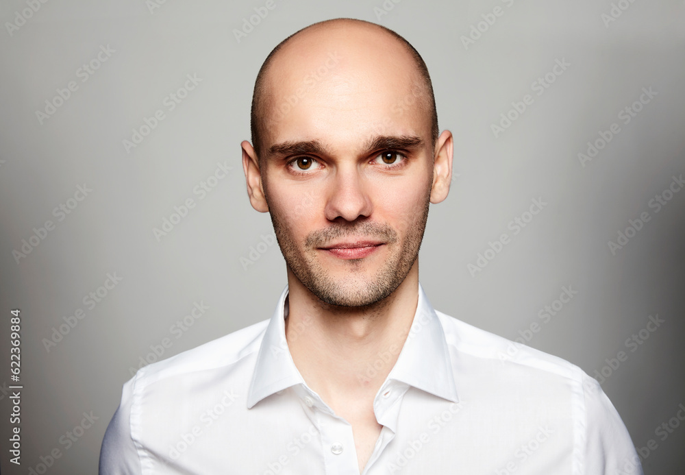 Studio shot of young man looking at the camera. Portrait on gray background. Studio shot of young man looking at the camera. Portrait on gray background.