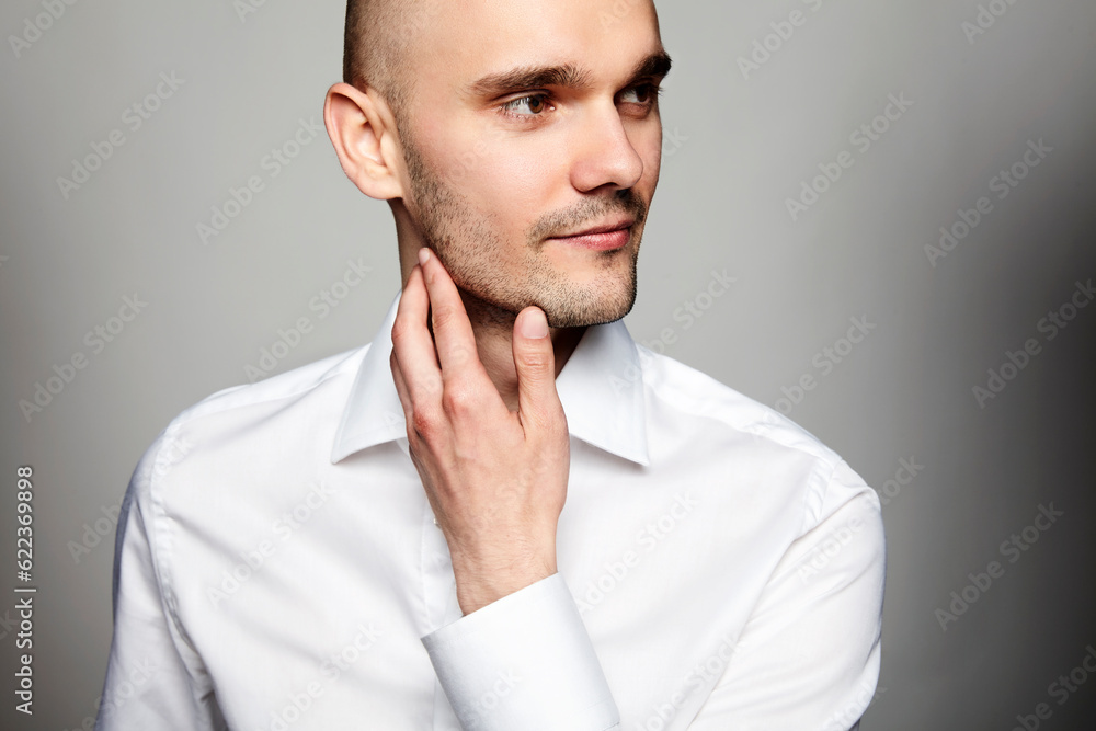 Close up portrait of young pensive man in white shirt. Close up portrait of young pensive man in white shirt.
