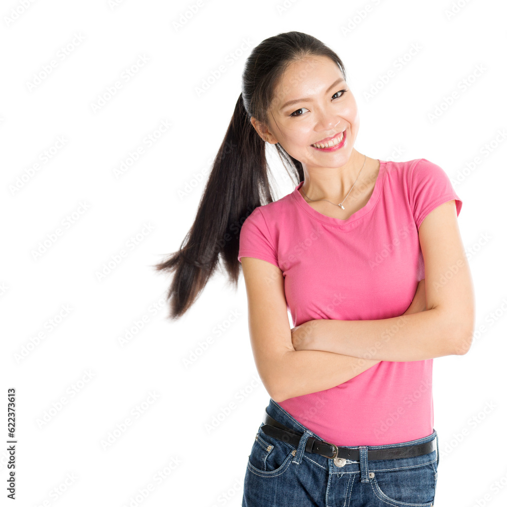 Obraz premium Portrait of happy young Asian girl in pink shirt and jeans with ponytail hair, standing isolated on white background.