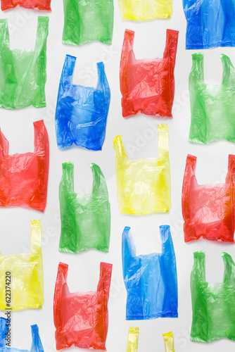 Top view pattern from colorful plastic bags. Single-use polythene packet, Eco trend to reduce disposable plastics, Biodegradable packaging waste, trendy photo pattern, vertical design background
