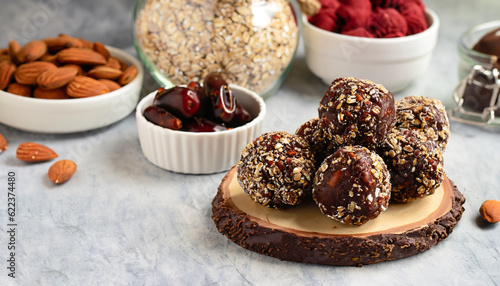 Healthy homemade paleo, hight protein chocolate energy balls with rolled oats, nuts, dates and almond flakes, dried raspberries. Raw vegetarian sweets. Sugar free, gluten free. Banner, copy space