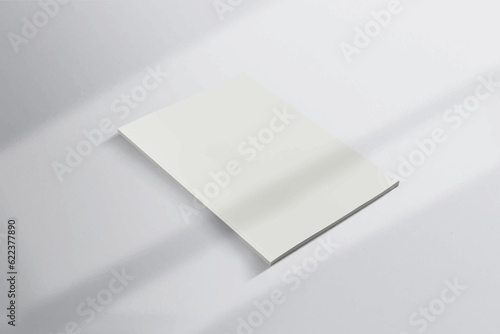 Realistic top view cover portrait A4 or A5 magazine or brochure booklet for stationery and branding. Mockup template isolated light grey background and leaf shadow overlay. 3D rendering.