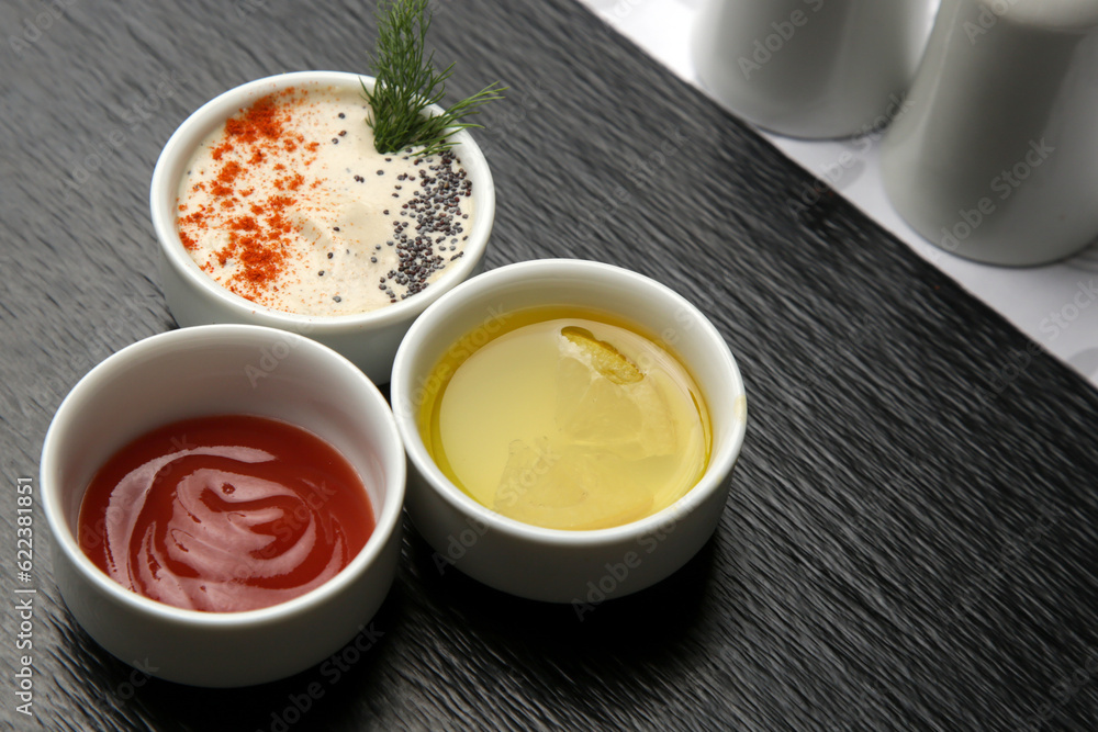 Different sauces and dips in bowls on the restaurant table
Different sauces and dips in bowls on the restaurant table