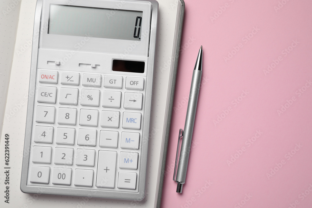 Calculator, notebook and pen on pink background, flat lay with space for text Calculator, notebook and pen on pink background, flat lay with space for text