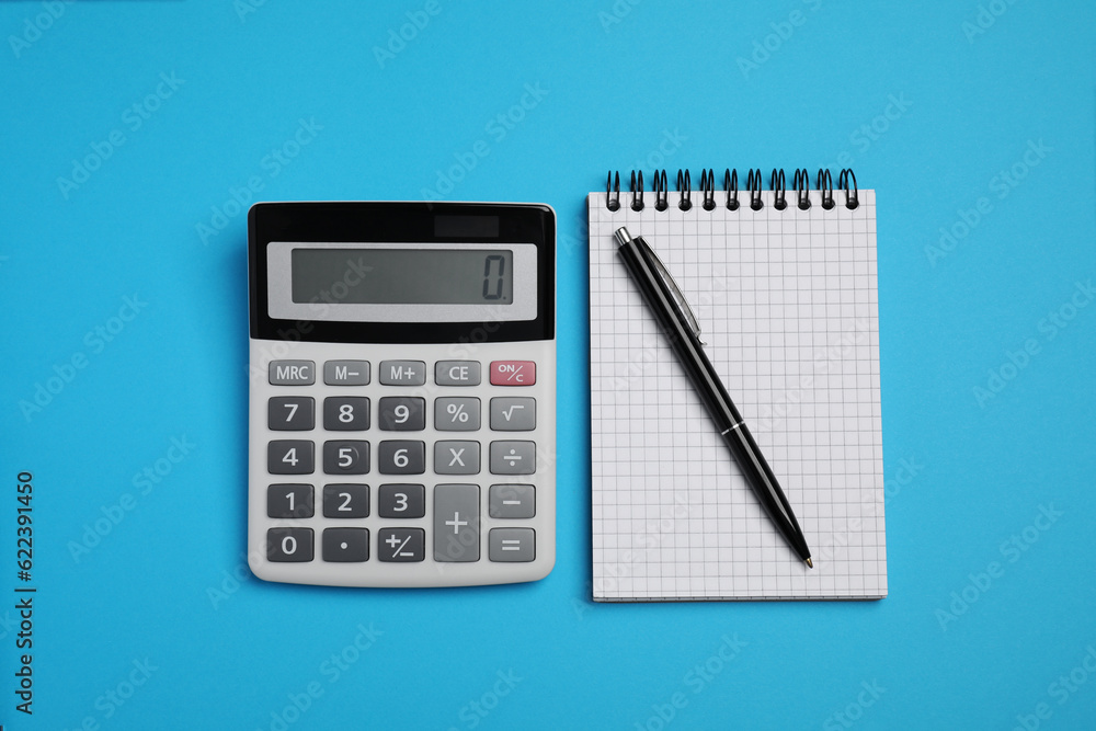 Calculator, notebook and pen on light blue background, flat lay Calculator, notebook and pen on light blue background, flat lay