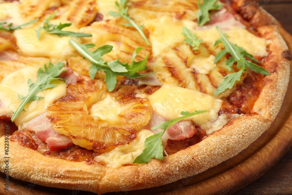 Delicious pineapple pizza with arugula on table, closeup Delicious pineapple pizza with arugula on table, closeup