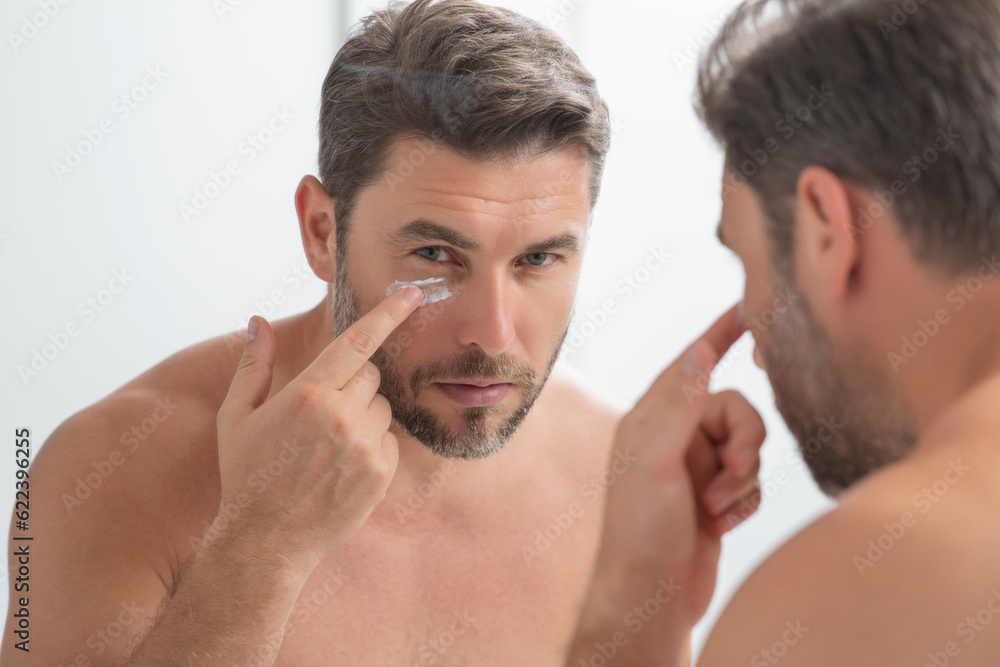 Obraz premium Cosmetic cream for man. Spa male model, skincare product for skin face. Morning mask for skin with anti-aging effect. Skin care. Male face cream. Man with perfect soft skin. Beauty cosmetic product.