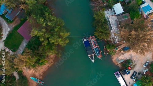 Aerial top view houses above water, fishing boats Ecuador harbor. Cinematic shot from top houses above water, fishing boats Ecuador harbor Dynamic shot houses above water, fishing boats Ecuador harbor © ShantiMedia