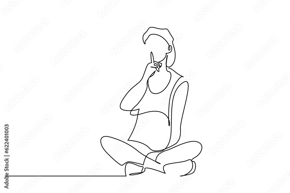 young woman sitting on floor making silence sign with forefinger showing warning young woman sitting on floor making silence sign with forefinger showing warning