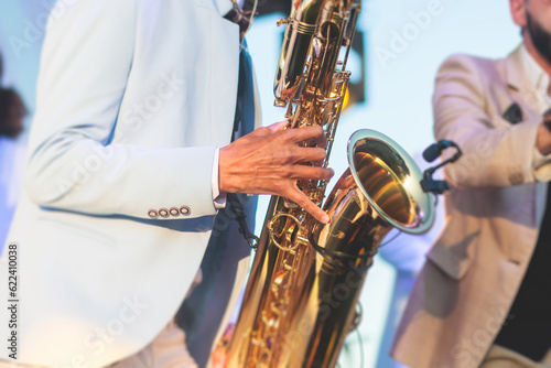 Murais de parede Concert view of saxophonist in a blue and white suit, a saxophone sax player wit