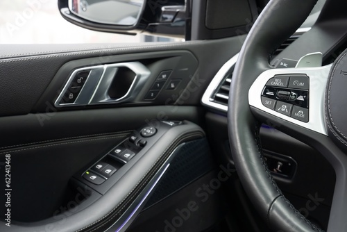 close up of a car handling door with options and steering wheel  © Universeal
