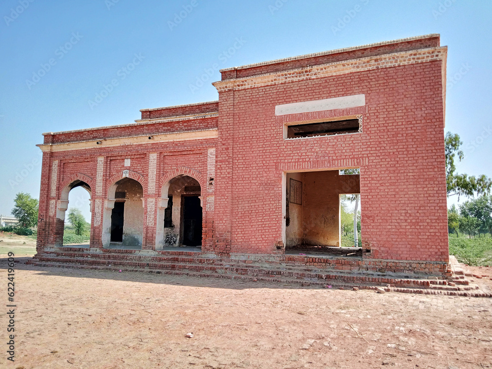 Old broken railway station building. Railway ruins with cinematic view of the building.