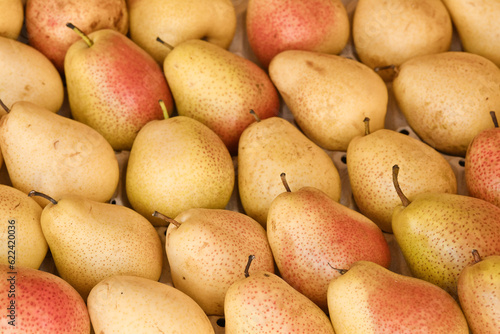 Juicy ripe pears in the store on the counter. Healthy food. Pear harvest concept. Selective focus.