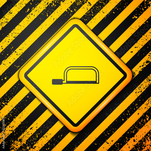 Black Hacksaw icon isolated on yellow background. Metal saw for wood and metal. Warning sign. Vector