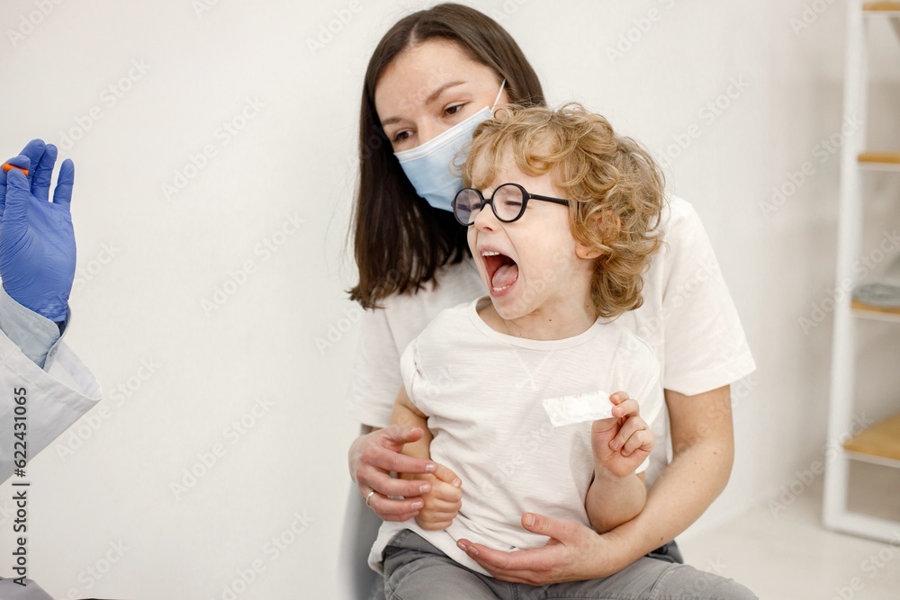 Little boy screaming because doctor is going to do vaccination