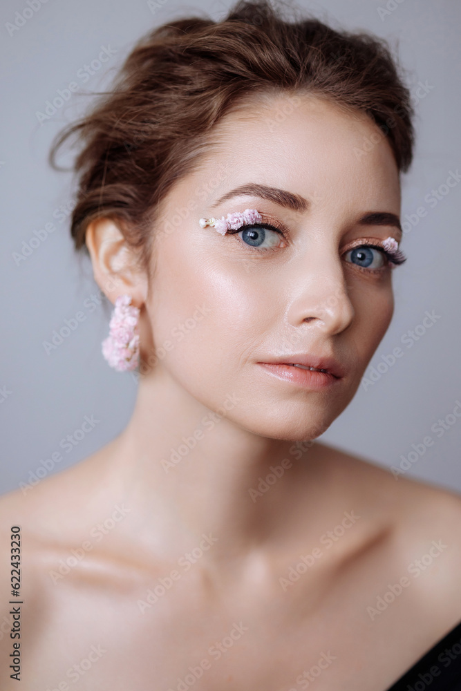 Portrait of a beautiful blondie woman with perfect skin and creative floral makeup look. Gypsophila eye makeup. The concept of cosmetic procedures, femininity, congratulations on women's day. Portrait of a beautiful blondie woman with perfect skin and creative floral makeup look. Gypsophila eye makeup. The concept of cosmetic procedures, femininity, congratulations on women's day.