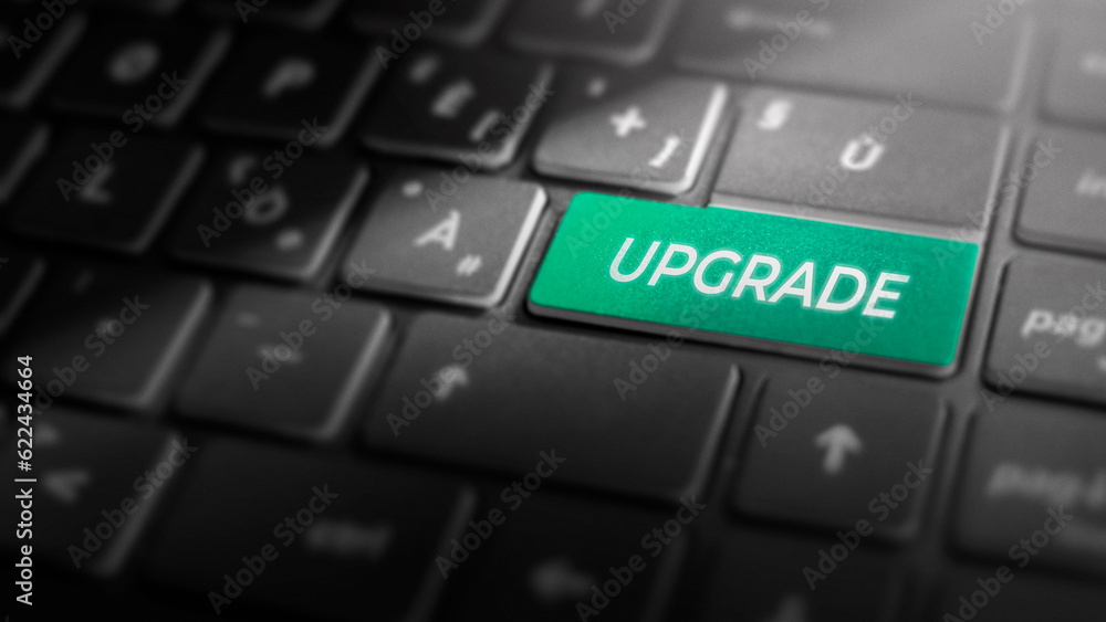 Upgrade key on laptop computer keyboard, green button on the dark grey keybord of a modern laptop notebook, technology concept for software updates and system upgrades, close-up Upgrade key on laptop computer keyboard, green button on the dark grey keybord of a modern laptop notebook, technology concept for software updates and system upgrades, close-up
