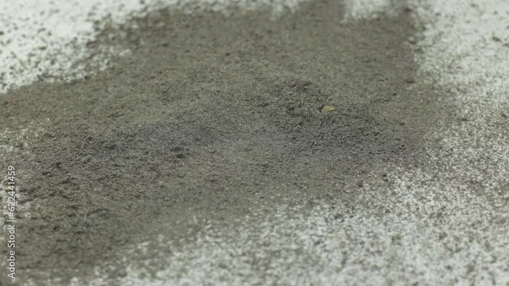 Cement on a white background. Cigarette ash is like cement, a lot of dust. Sprinkled gray dust on a white background. Gray material, very thin Cement on a white background. Cigarette ash is like cement, a lot of dust. Sprinkled gray dust on a white background. Gray material, very thin