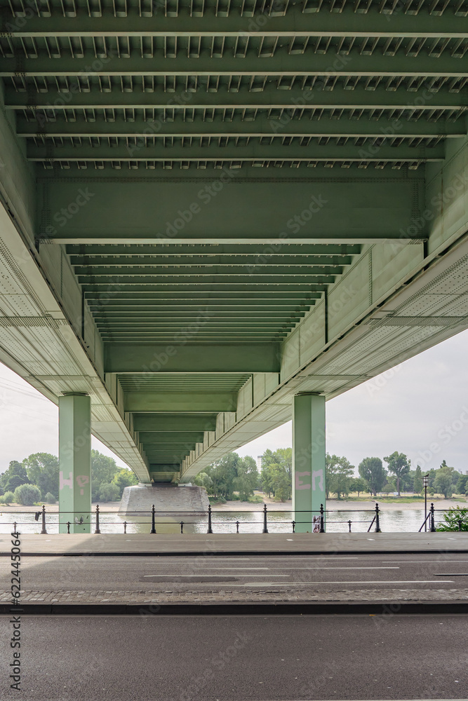 view under the bridge across the street and river in the city view under the bridge across the street and river in the city