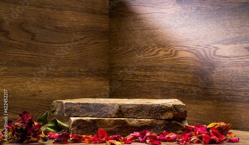 podium with dry rose petals.composition with rose petals and stone on brown wooden background for podium background product presentation