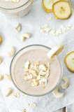 Cashews banana oat flakes smoothie in a glass