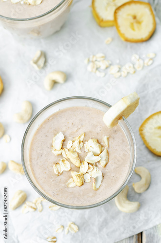Cashews banana oat flakes smoothie in a glass