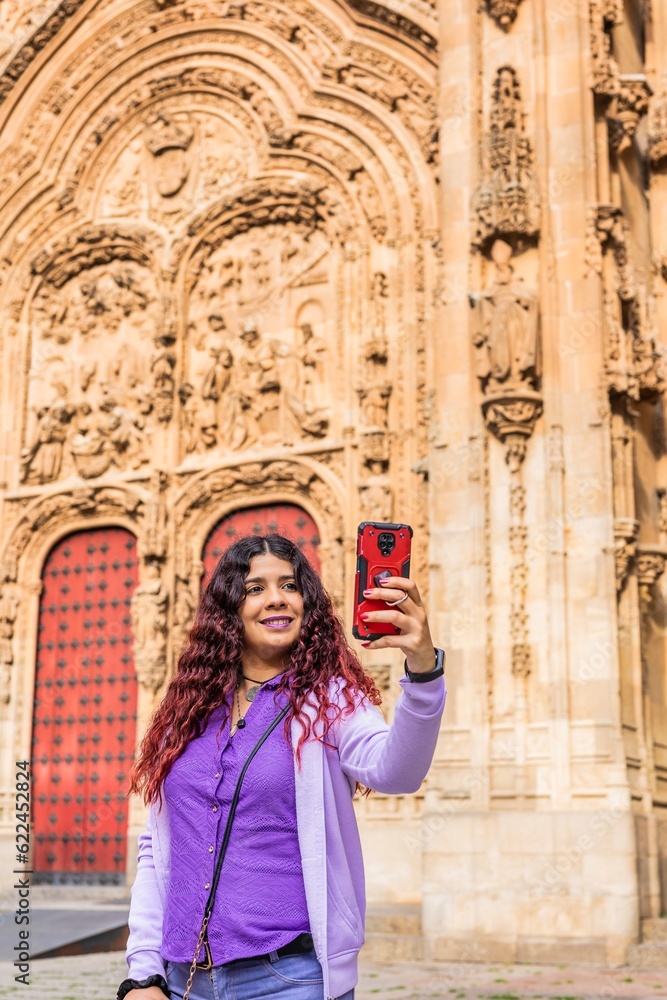 Smartphone technology holiday vacation. Latin American mid-female. Lifestyle selfie in Salamanca.