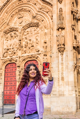 Smartphone technology holiday vacation. Latin American mid-female. Lifestyle selfie in Salamanca. © Sangiao_Photography