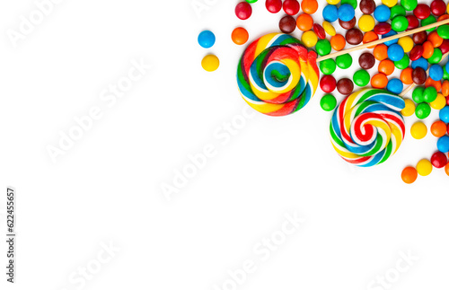 Colorful lollipops and different colorful round candy. Top view.
