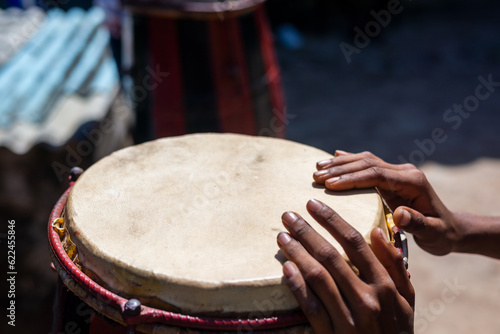 Leinwand Poster Hands of a musician standing still on a Brazilian atabaque.