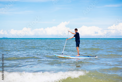 Child on stand up paddle. Water and beach sport © famveldman