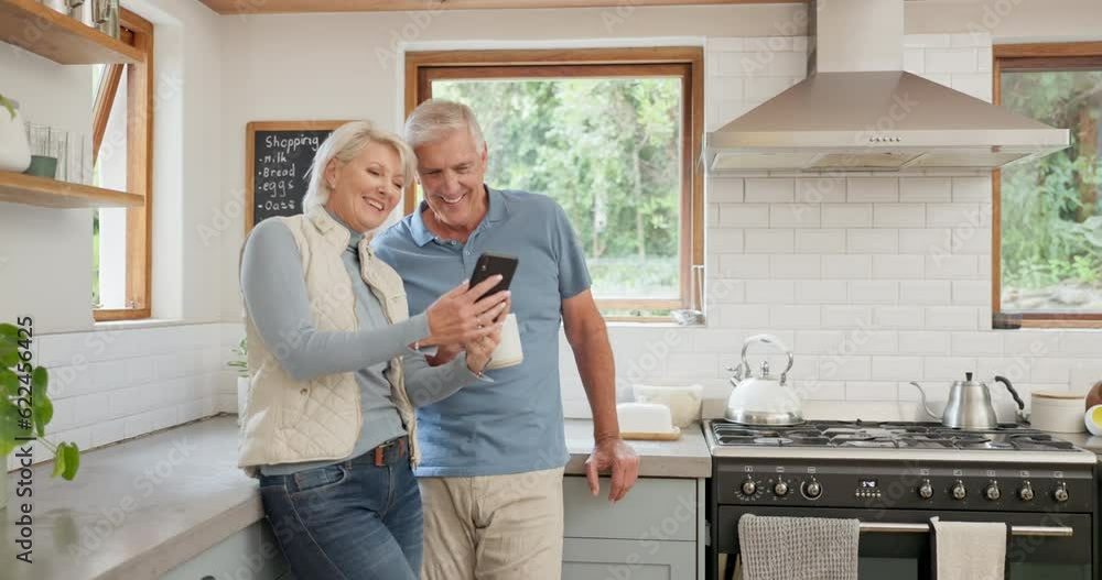 Phone, coffee and senior couple in kitchen while networking on social media or the internet together. Happy, laughing and elderly people in retirement drinking a cappuccino and browsing on cellphone. Phone, coffee and senior couple in kitchen while networking on social media or the internet together. Happy, laughing and elderly people in retirement drinking a cappuccino and browsing on cellphone.