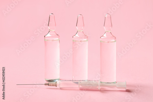 Medical ampules on pink bac...