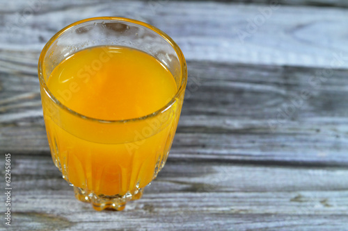 Fresh mango fruit Juice with tropical delicacy, mangoes are nutritionally rich fruit with distinctive flavor, smell, taste, selective focus of Egyptian Mango fruit Juice isolated on wood photo