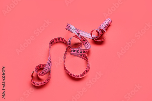 New measuring tape on red background