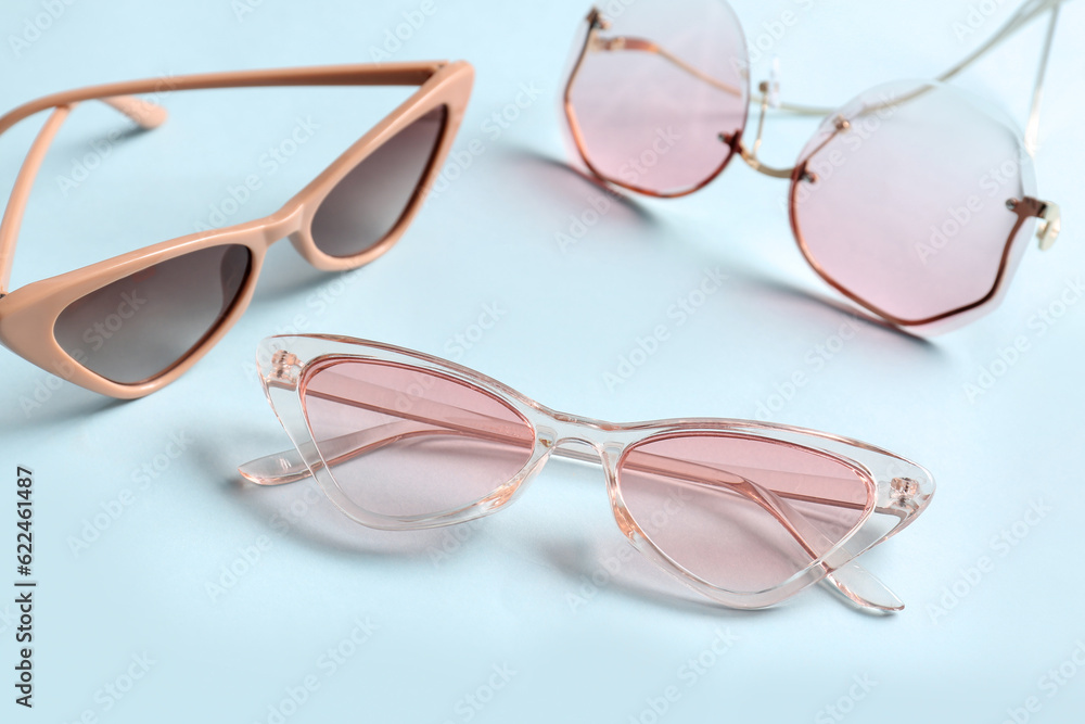 Different stylish eyeglasses on blue background Different stylish eyeglasses on blue background
