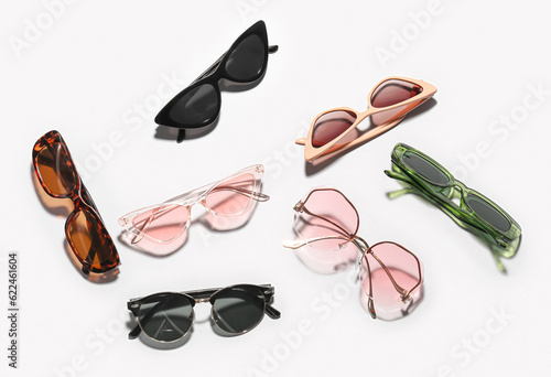 Different new stylish eyeglasses on white background