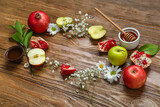 Frame made of fresh fruits, flowers and honey on wooden background. Rosh hashanah (Jewish New Year) celebration
