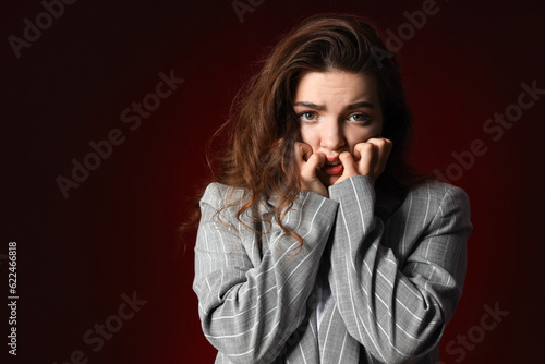 Young woman having panic attack on dark background