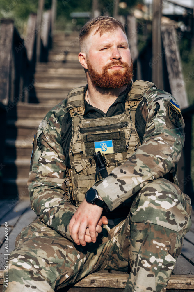 Portrait of Ukrainian soldier in uniform on the street