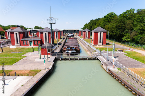 Bild auf Leinwand Cargo boats in water basin at Hindenburgschleuse mittellandkanal canal water basin, lifted to higher surface level ready to leave the hub