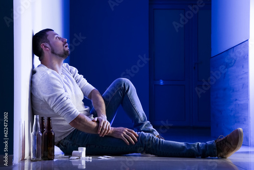 Male drug addict sitting in...