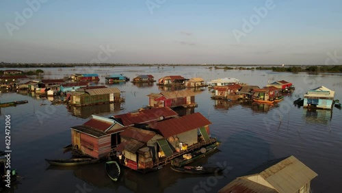 Houses on water, 4k Drone footage of a floating village during sunset, Kampong Phluk, Cambodia, Boats, fisherman