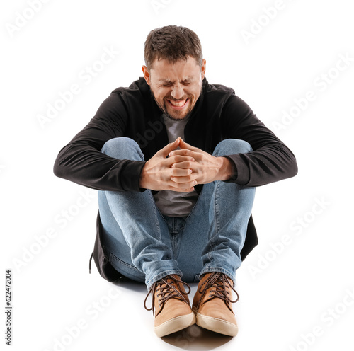 Male drug addict sitting on...