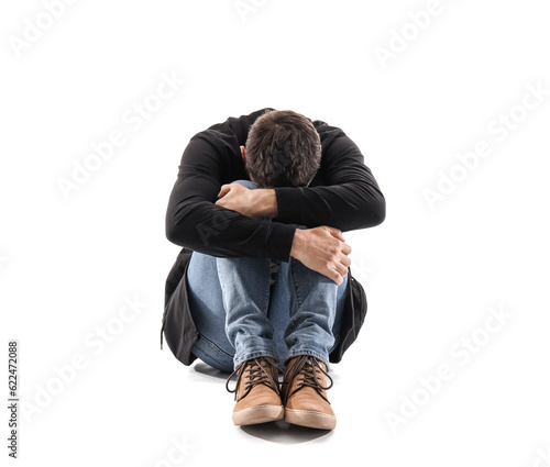Male drug addict sitting on...